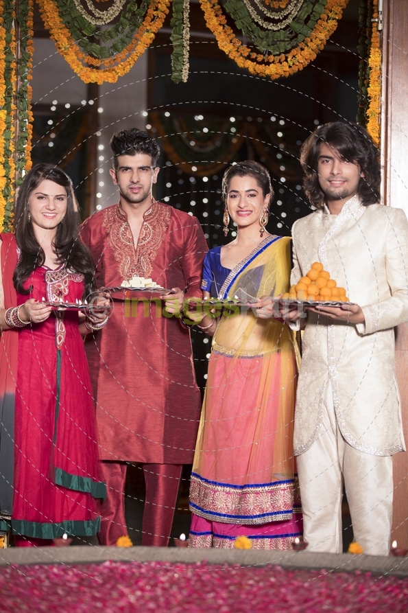 couple in traditional wear standing with thalis