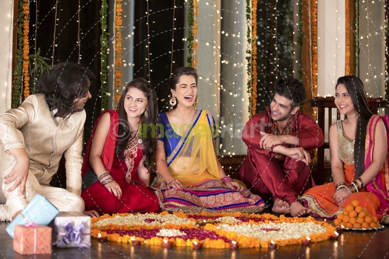 couples celebrating diwali and decorating home