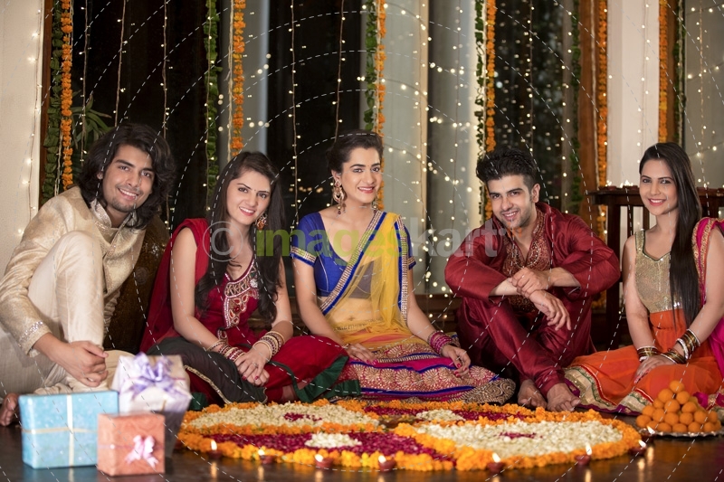 couples celebrating diwali and decorating home