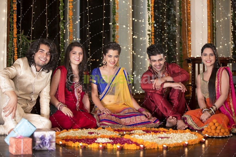 couples celebrating diwali and decorating home