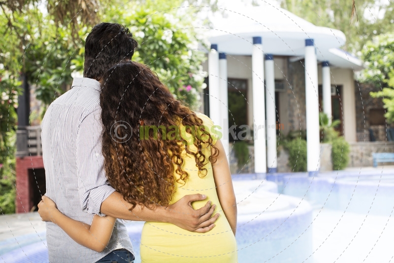 back view of the couple looking at villa
