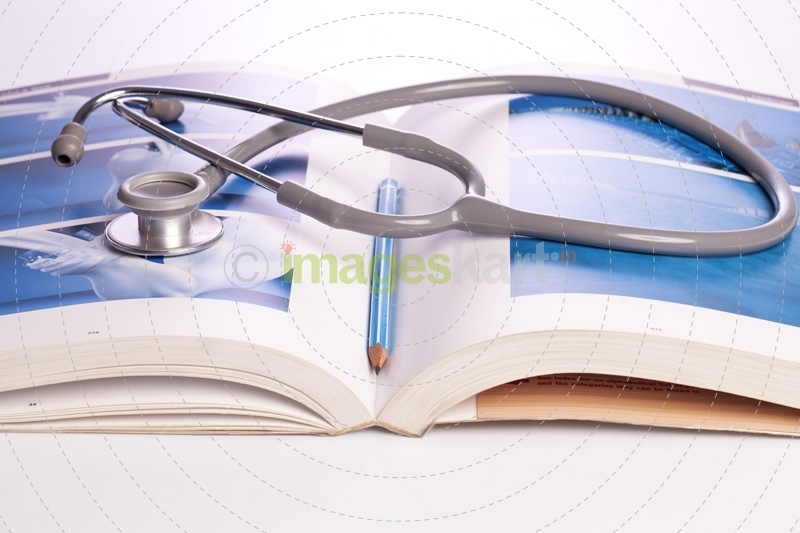 stethoscope and book isolated on white