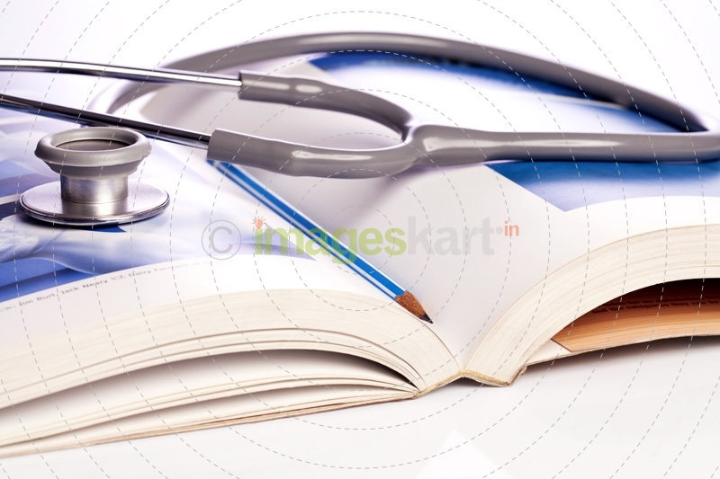 stethoscope and book isolated on white