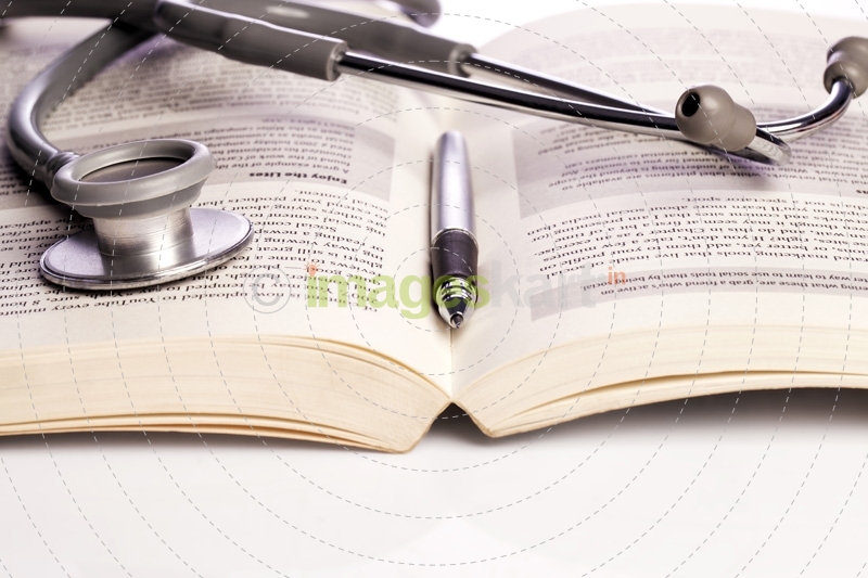 stethoscope and book isolated on white