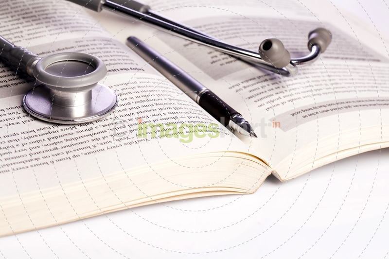 stethoscope and book isolated on white