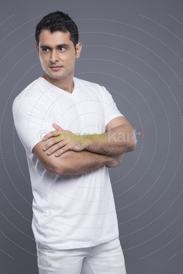 man standing with hands folded 