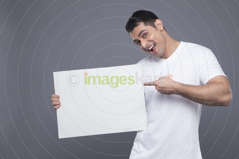 man in white posing with a message board 