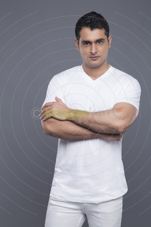 man standing with hands folded 