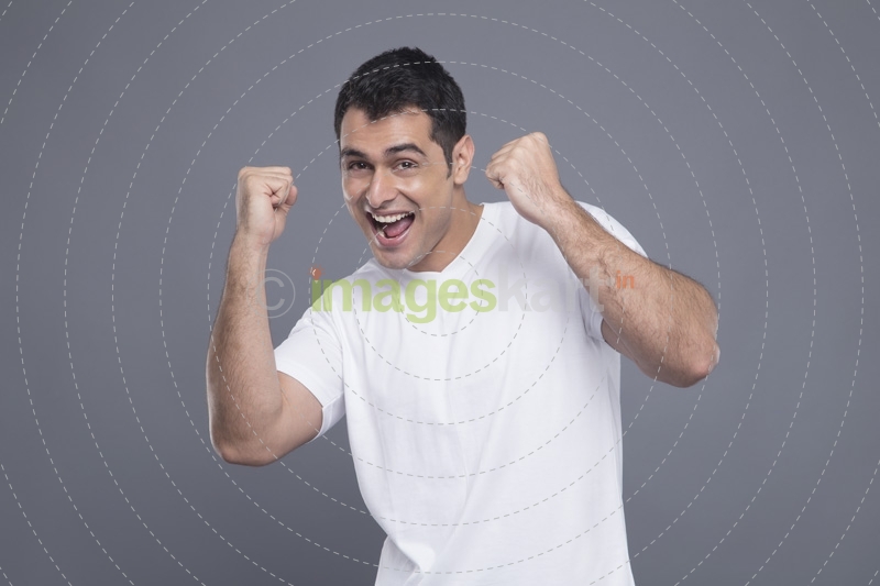 man in white cheering 