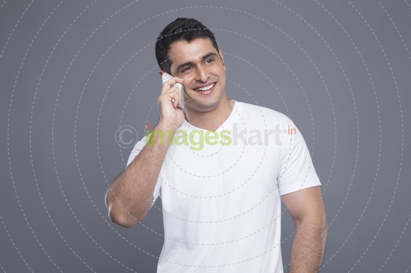 man in white t shirt talking on phone 