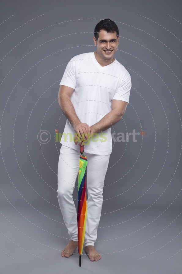 man posing with a colourful umbrella 