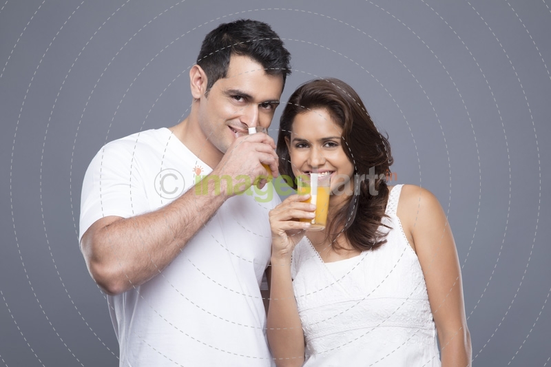 couple drinking orange juice 