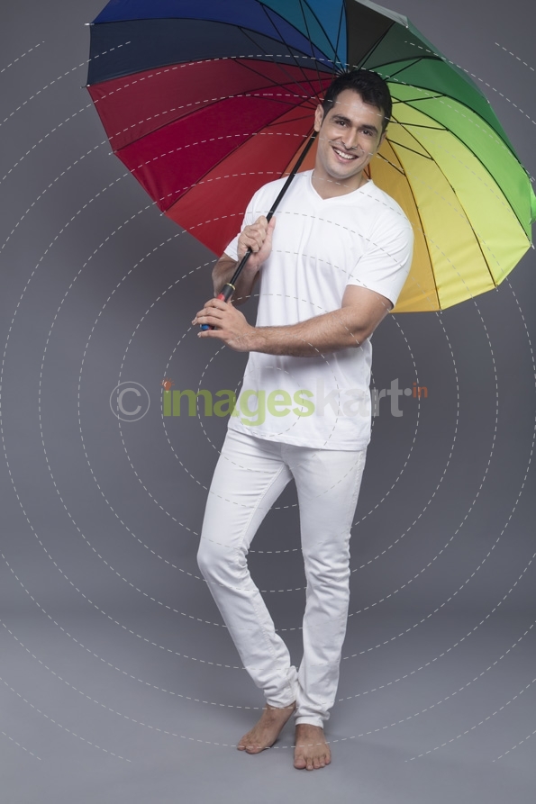 man posing with a colourful umbrella 
