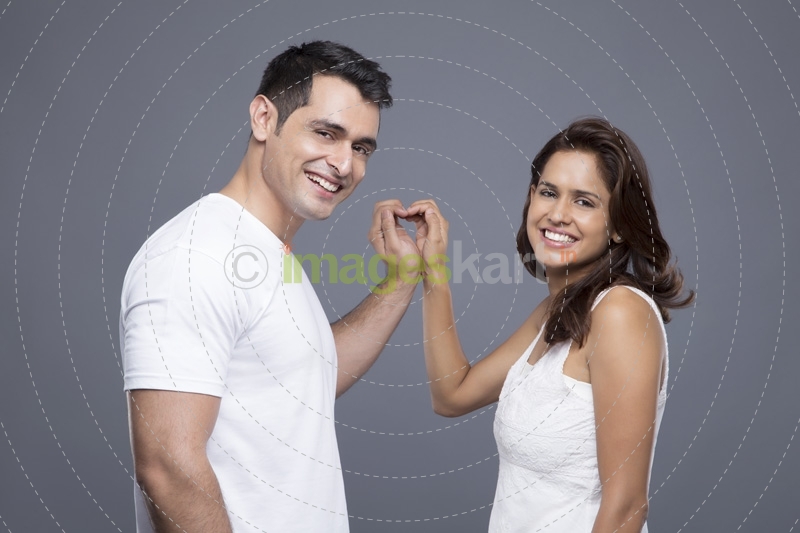 couple showing off love hand gesture