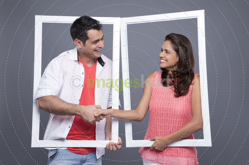 couple shaking hands through the frame 