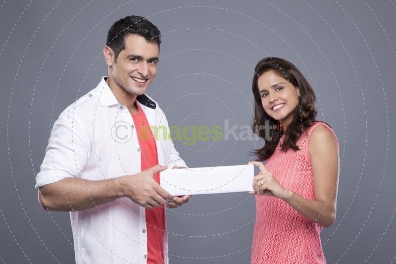 couple holding a message card