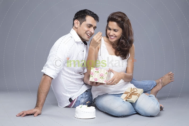 husband giving wife a present on birthday