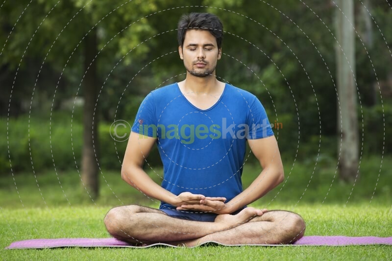 boy performing yoga in parK