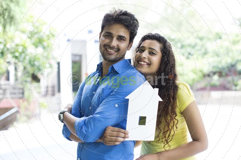 couple showing home cutout outside villa