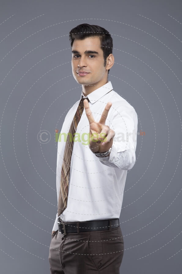 professionally dressed doing victory gesture