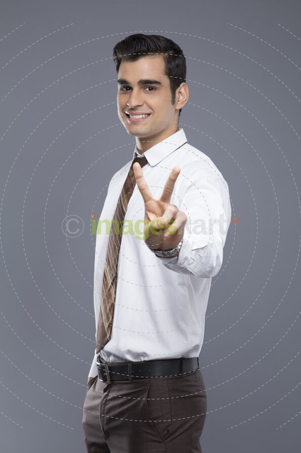professionally dressed doing victory gesture