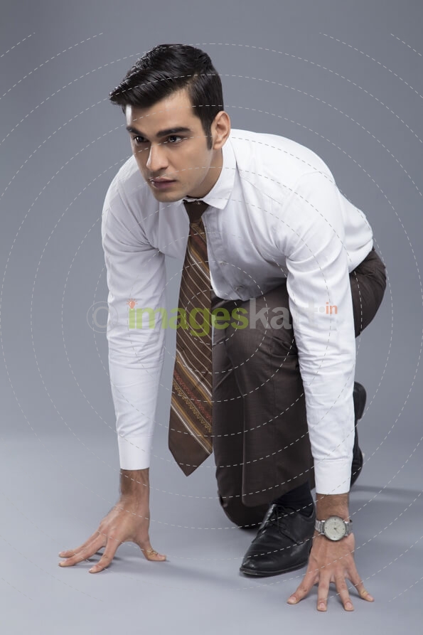 professionally dressed man ready to run