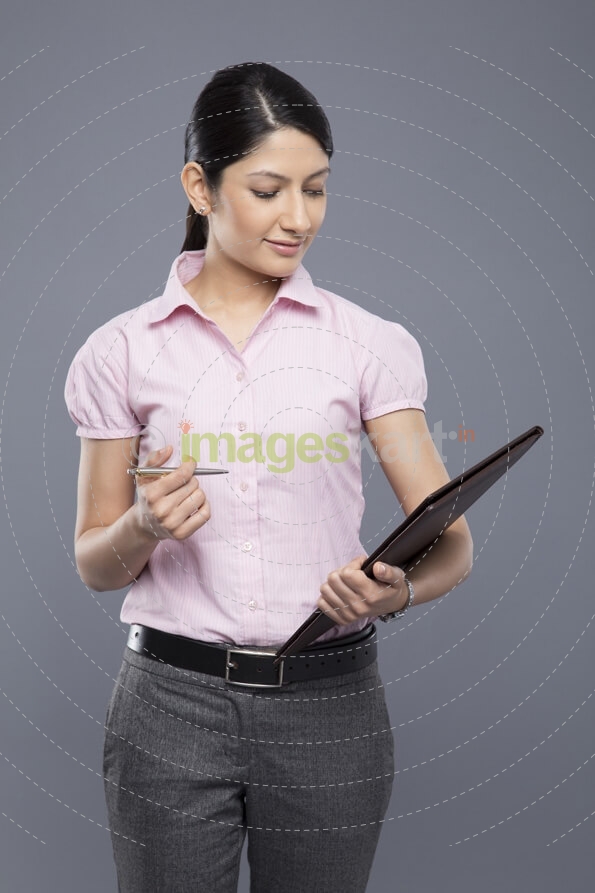 portrait of a businesswoman holding a file