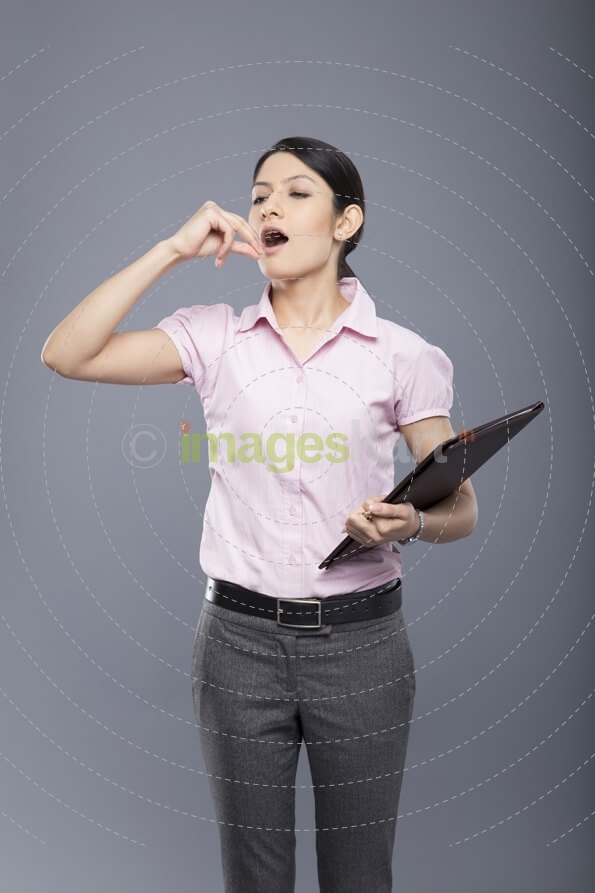 young businesswoman bored and yawning