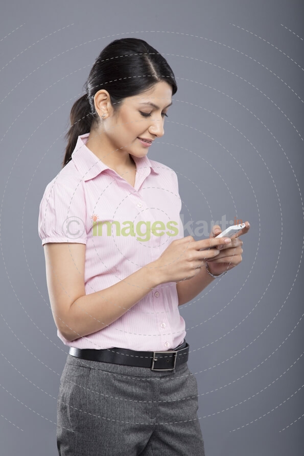 young business woman reading messages on mobile phone