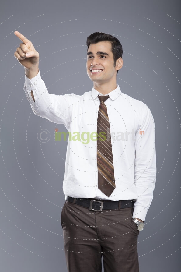 professionally dressed man pointing hands in the air 