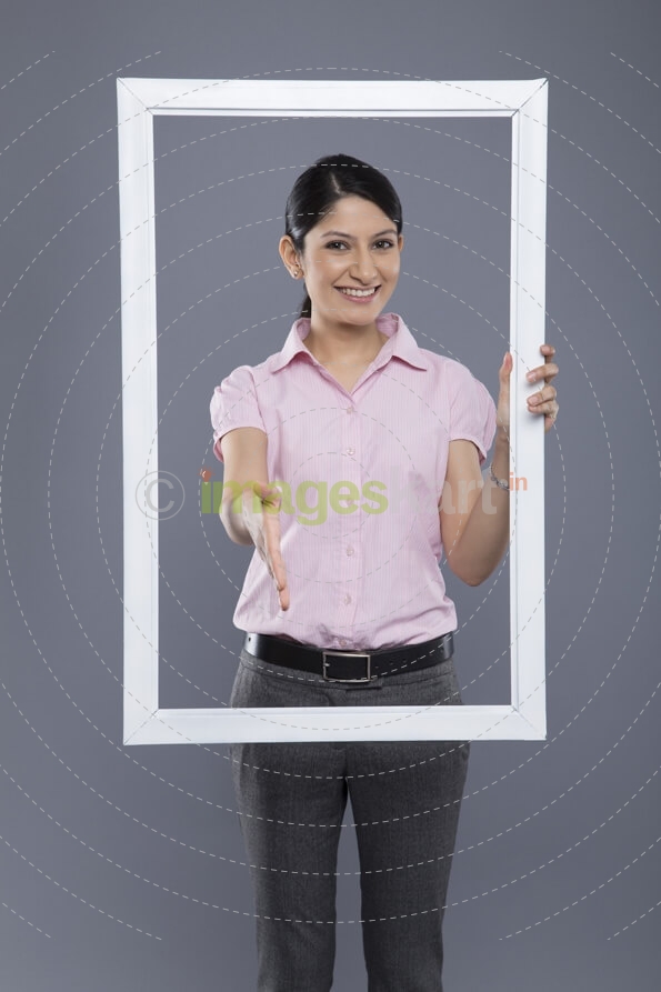 business woman standing with a frame