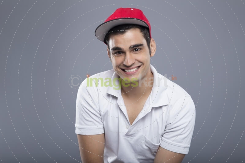 man in casuals posing with cap