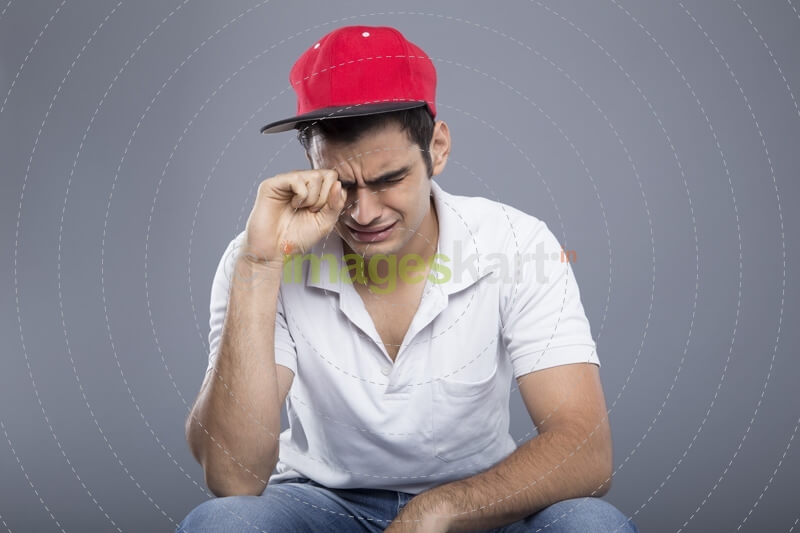 young man sitting and crying
