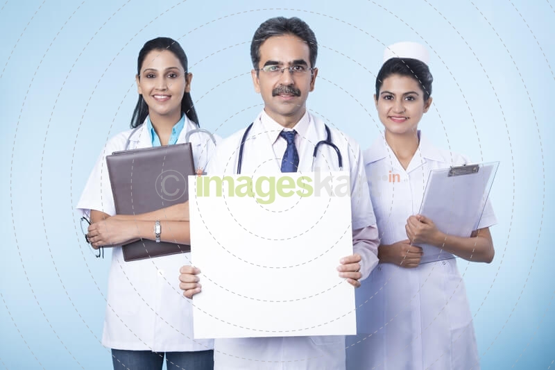 doctor with his team with a message board 