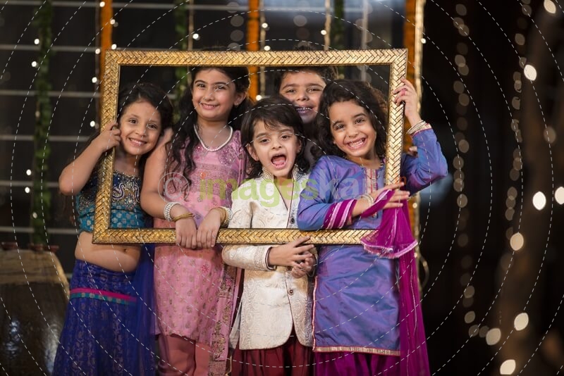 cheerful small group of kids holding a picture frame