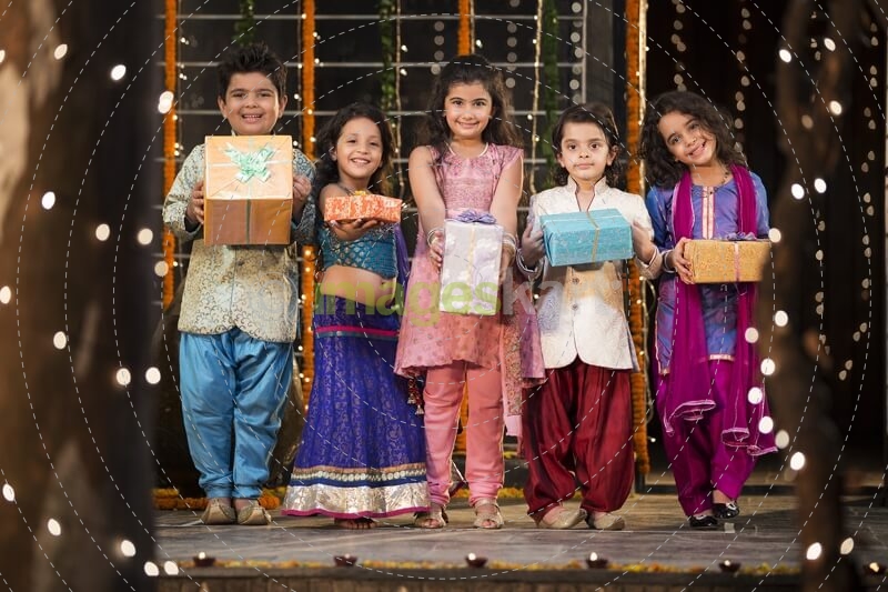group of kids carrying gifts and presents on diwali