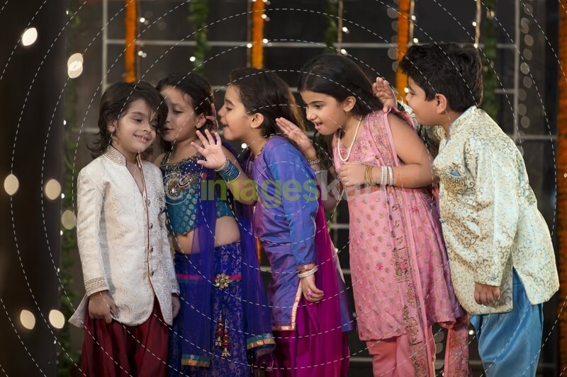 cheerful group of kids whispering in each others ears