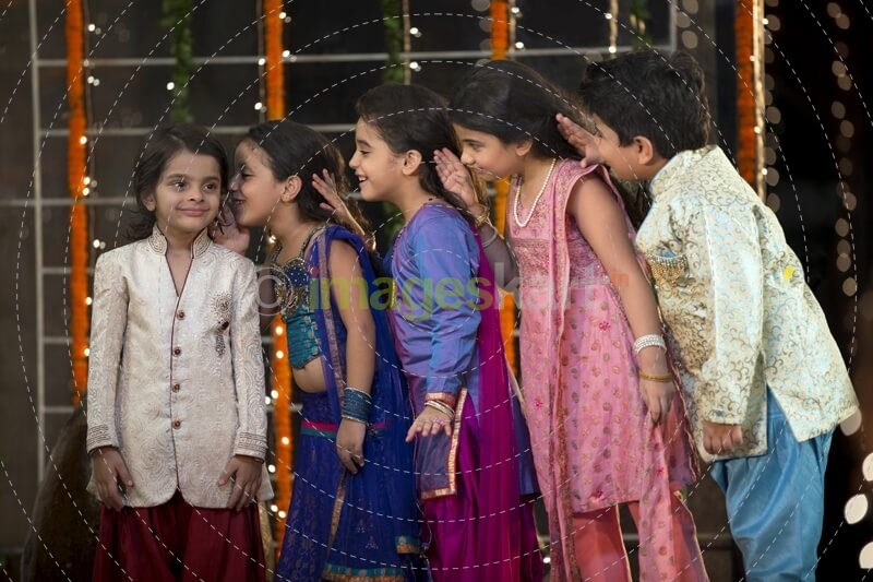 cheerful group of kids whispering in each others ears