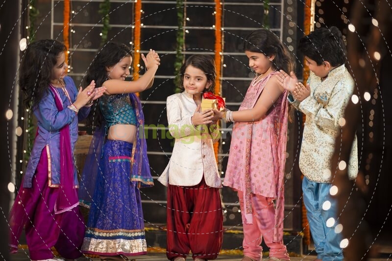 group of kids carrying gifts and presents on diwali