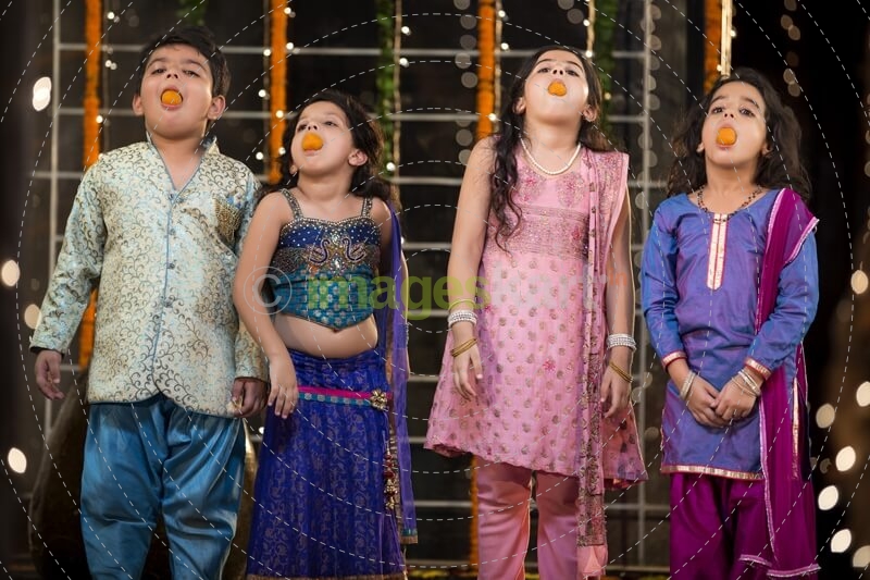 kids eating ladoo on diwali 
