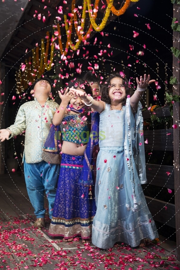 kids playing with rose petals on diwali 