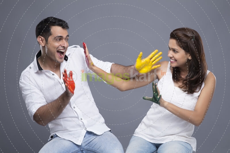 couple applying colours to each other 