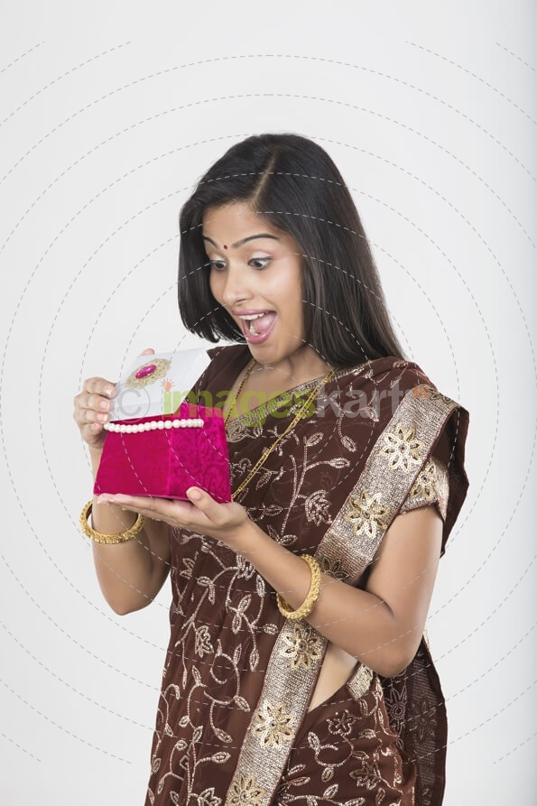 woman in saree with a jewellery box 