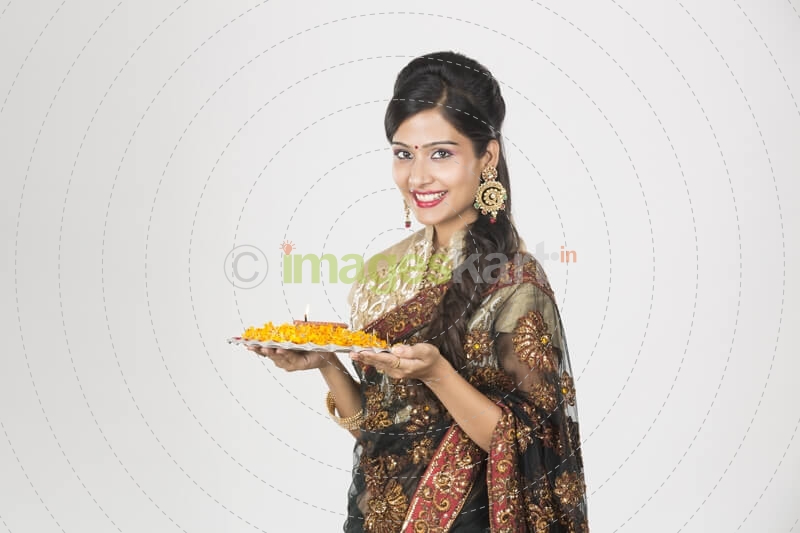 woman in saree with pooja thali 