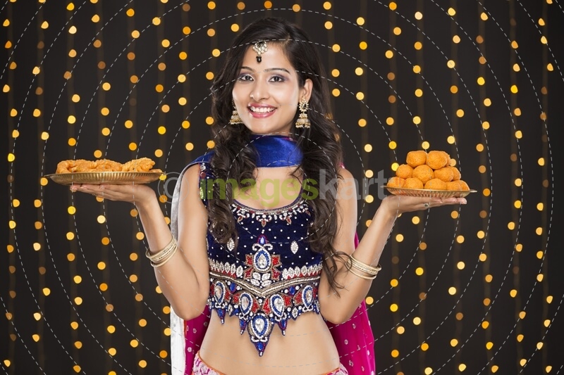 woman in ethnic wear with sweets 