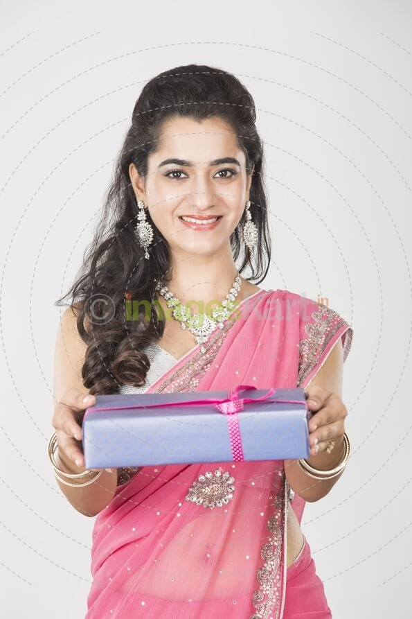 woman in ethnic wear with a gift 