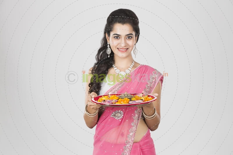 woman in saree with pooja thali 