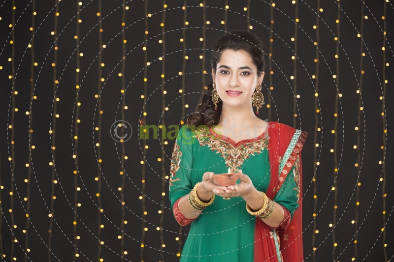 girl holding diya and posing 