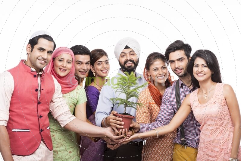 people from all religions posing with a plant 