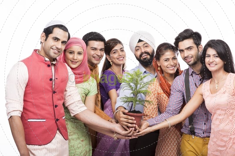 people from all religions posing with a plant 